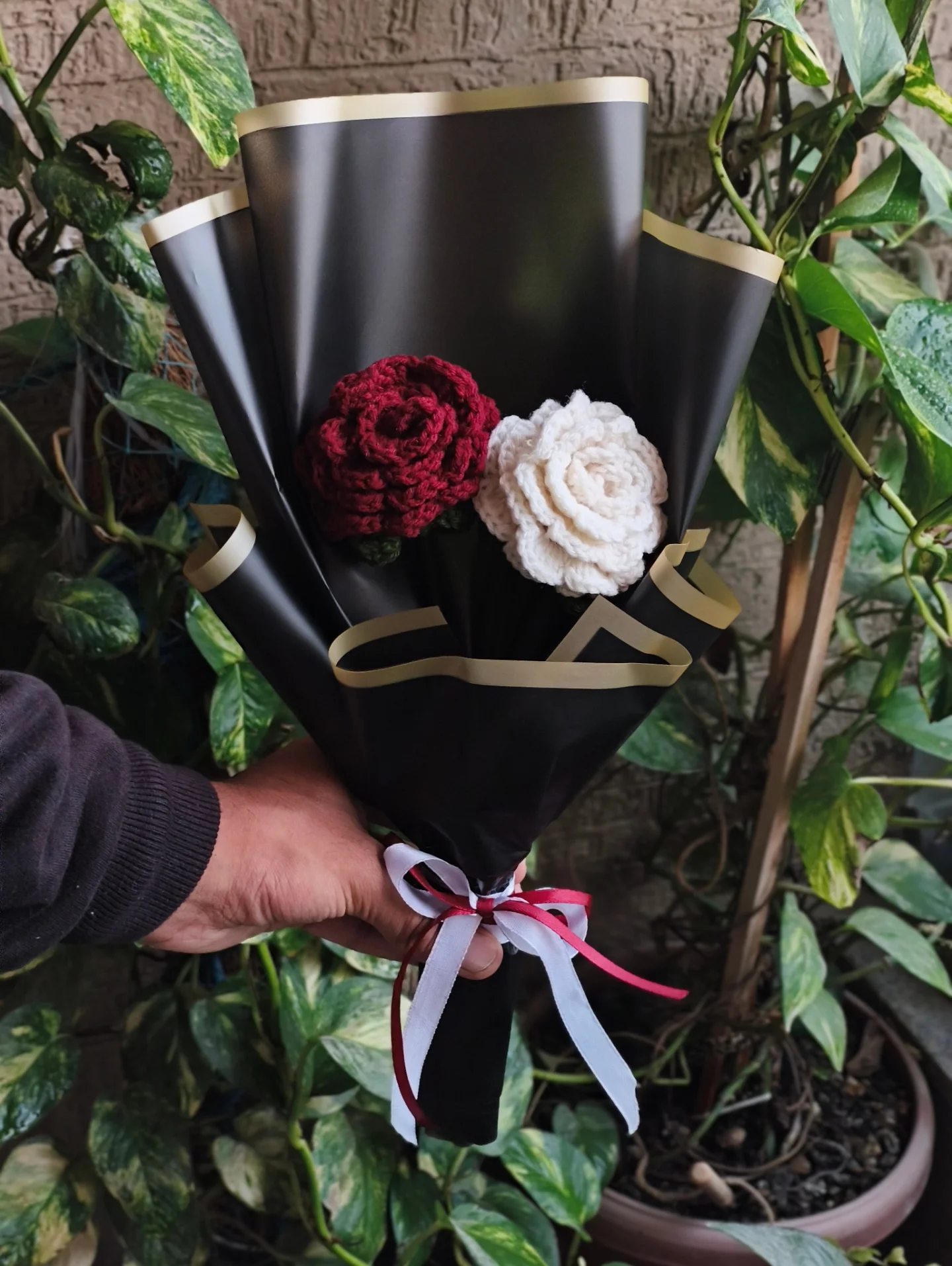 Red and cream roses in artisan black paper.
